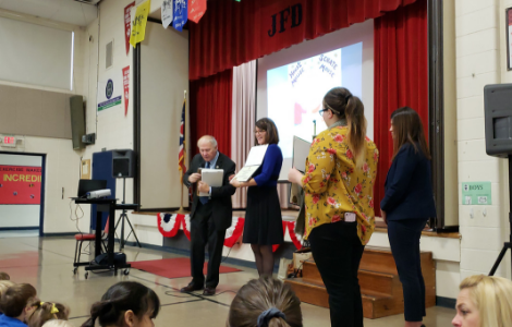 Steve Chabot presents plaque to principal Riesenberger